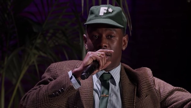 Tyler, the Creator is pictured speaking into a microphone