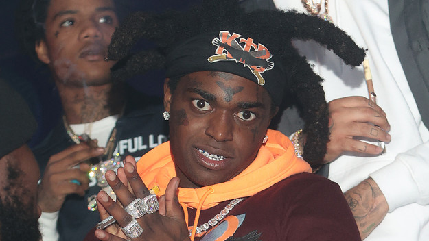 Kodak Black stares down camera while at a club.