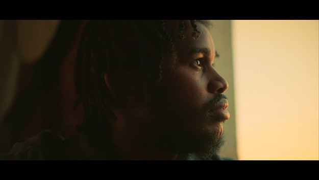 A screenshot from the video to Malik Moses and Bas' "SHow Me Something" video.