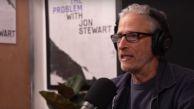 Jon Stewart speaks into a microphone