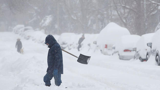 A person shovels snow from a driveway in Toronto, Ontario, Canada, on January 17, 2022.