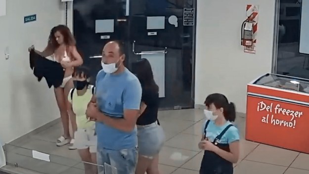 A woman takes off her dress to wear as mask