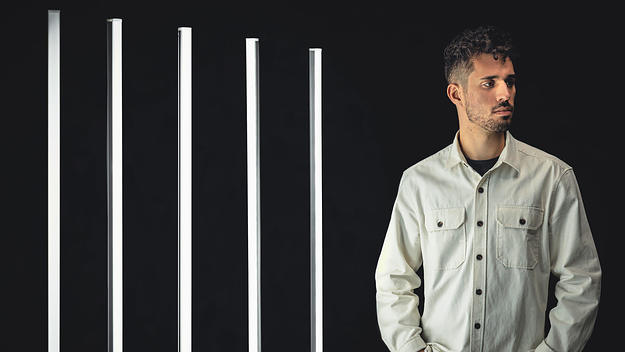 Montreal producer Anomalie posing against black background