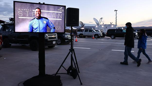 Members of the media are gathered before Blue Origin’s New Shepard lifts-off