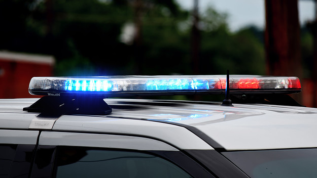 Police car flashing lights close up. Top of police car with flashing lights in daytime.
