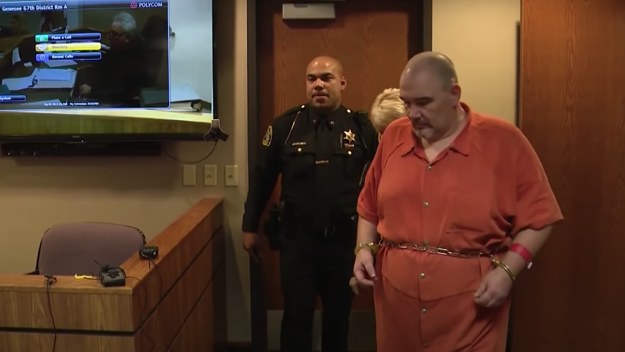 A white man is seen in handcuffs in court.