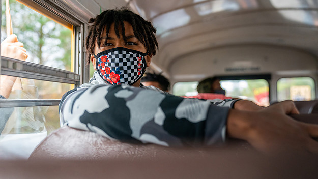 Solomon Irama on a bus with a mask