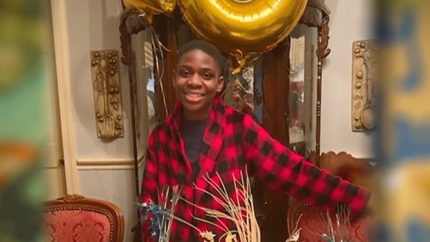 Adeola "Abraham" Olagbegi stands by birthday balloons
