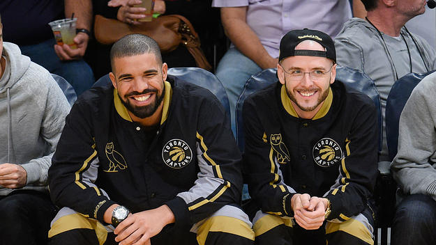 Drake and Noah "40" Shebib smiling at a Toronto Raptors game