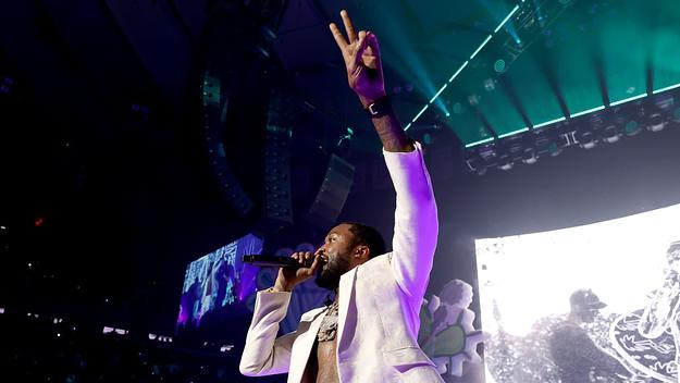 Meek Mill performing on stage.