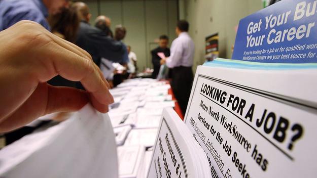 A person flips through job applications