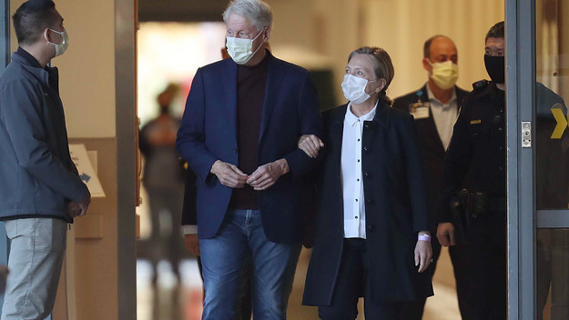 Bill Clinton and his wife Hilary, exiting hospital
