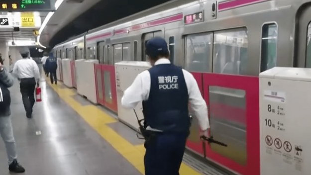 Police stand outside of a Tokyo train