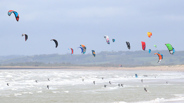 Kitesurfers enjoy with windy conditions in Camber, East Sussex