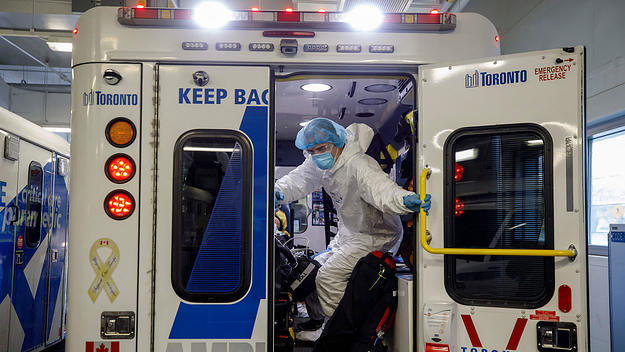 Paramedics and healthcare workers transfer a patient from Humber River Hospital's Intensive Care Unit to a waiting air ambulance as the hospital frees up space In their ICU unit, in Toronto, Ontario, Canada, on April 28, 2021.