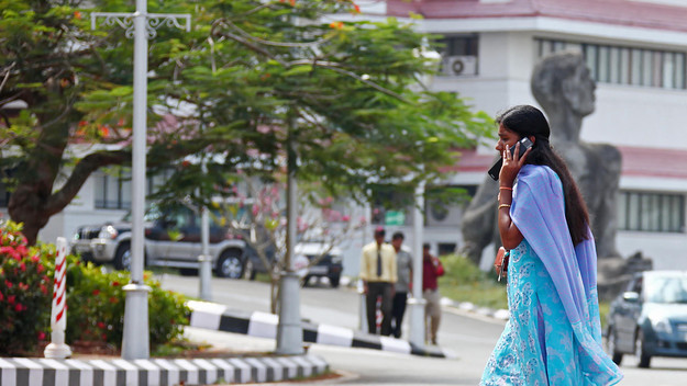 Indian businesswoman with a mobile phone at the center of technology in Kerala called technopark.