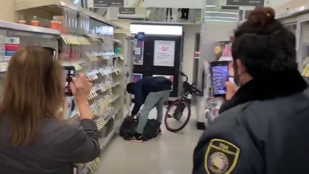 Screenshot of a thief stealing from Walgreens in broad daylight.