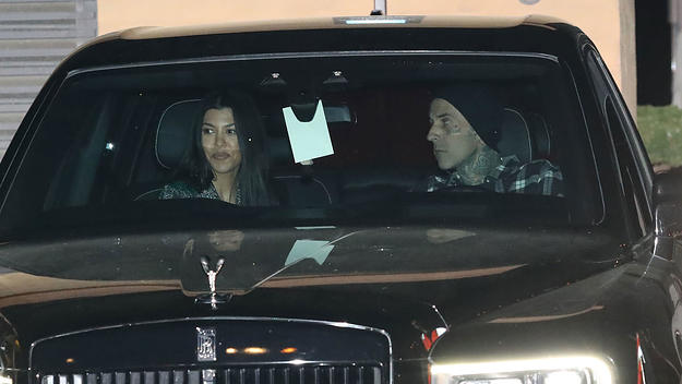 Kourtney Kardashian and Travis Barker being hounded by the paparazzi.