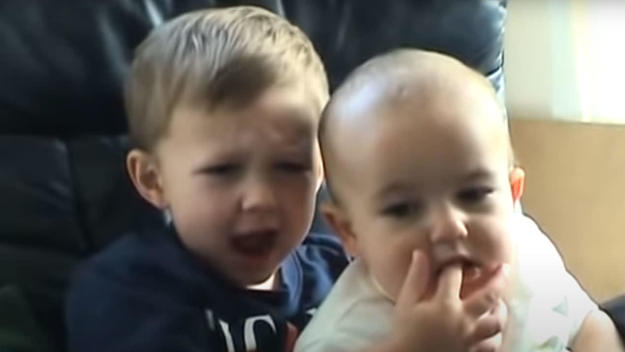 Charlie biting his brother's finger.