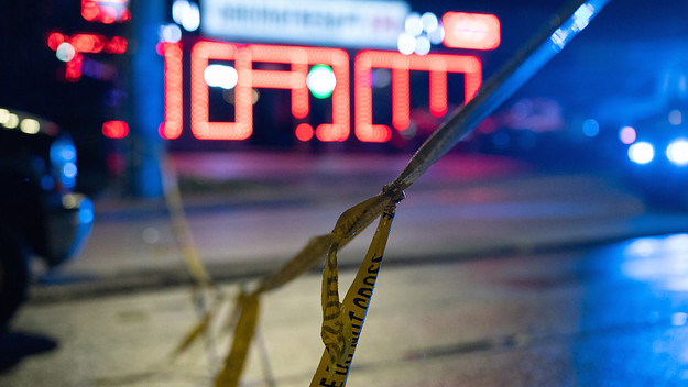 Police tape is seen outside a massage parlor where a person was shot and killed
