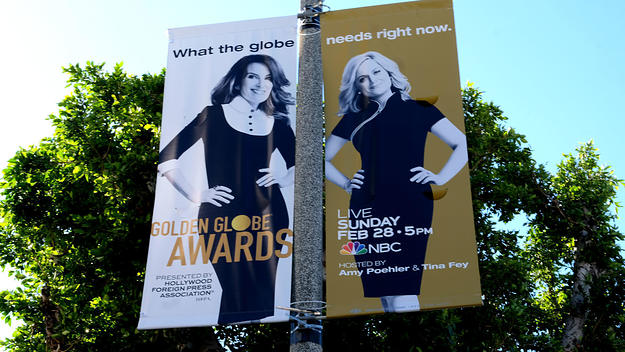 A sign advertises Tina Fey and Amy Poehler hosting the 2021 Golden Globes.