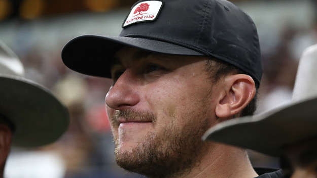 Johnny Manziel watches the Texas A&M Aggies and the Arkansas Razorbacks