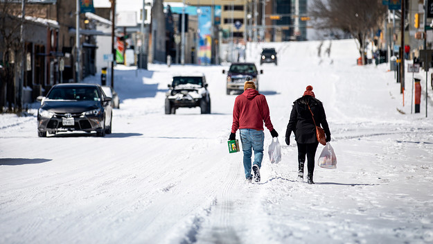 Texans walking through snow following winter storm