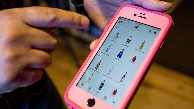 Kevin Casey, manager of Old Port Spirits & Cigars, demonstrates the app Drizly