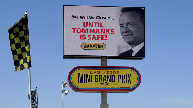 A digital billboard displays a humorous message about actor Tom Hanks
