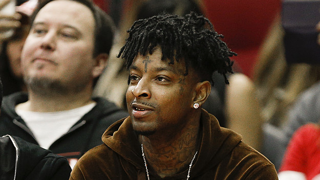 21 Savage watches from court side as the Denver Nuggets played the Houston Rockets