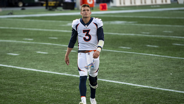 Drew Lock #3 of the Denver Broncos walks off the field