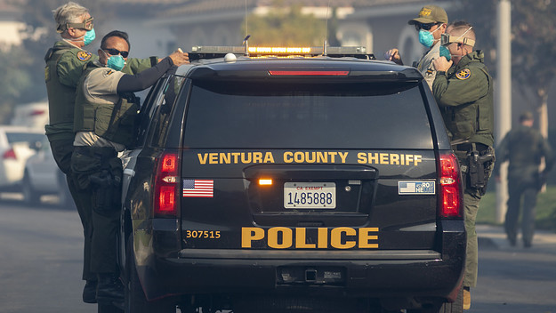 Sheriff's deputies evacuate a threatened neighborhood