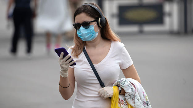A woman in Moscow stares at her iPhone.