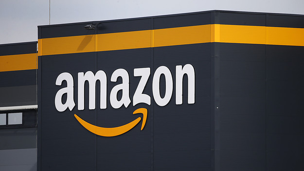 The logo of Amazon is seen on the facade of the company logistics center.