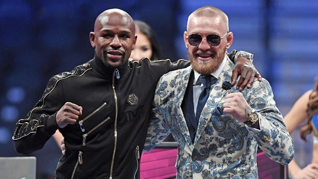 Floyd Mayweather poses alongside Conor McGregor.