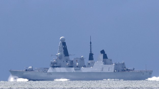 The HMS Defender passes the Isle of Wight after leaving Portsmouth Harbour.
