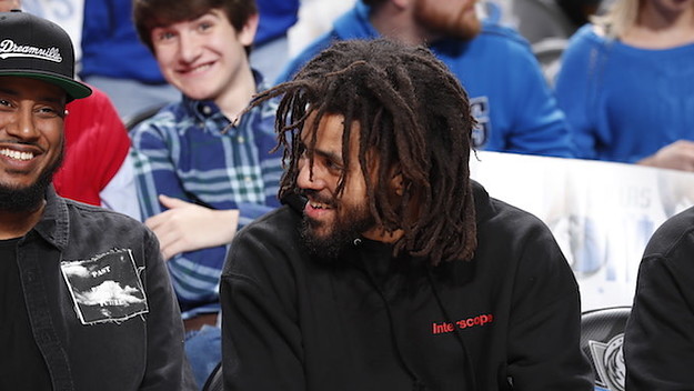 J. Cole watches the game between the Detroit Pistons and Dallas Mavericks.