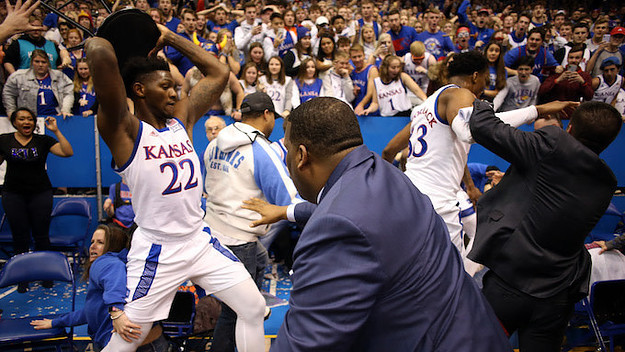 Silvio De Sousa #22 of the Kansas Jayhawks picks up a chair during a brawl.