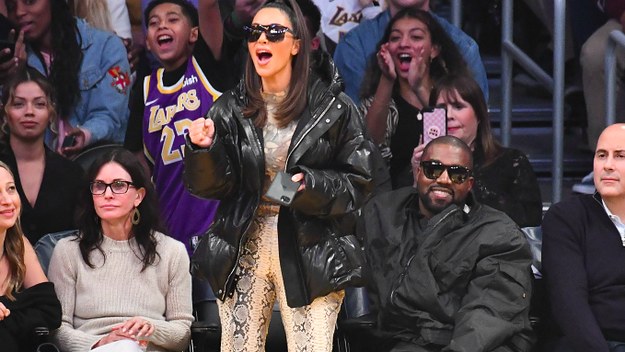 Kim Kardashian and Kanye West attend a basketball game