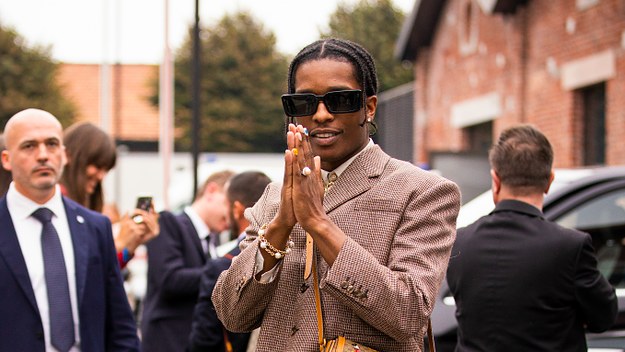 ASAP Rocky, wearing brown blazer, blue jeans, Gucci bag and Gucci shoes