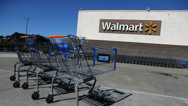 Shopping carts sit in front of a Walmart store