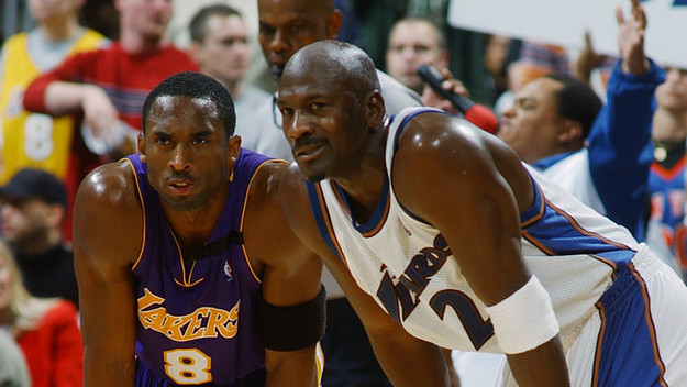 Kobe Bryant #8 of the Los Angeles Lakers rests next to Michael Jordan