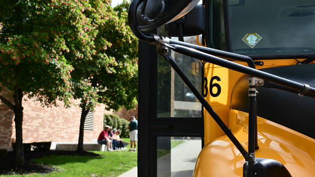 School Bus Close up and Waiting Bus Drivers