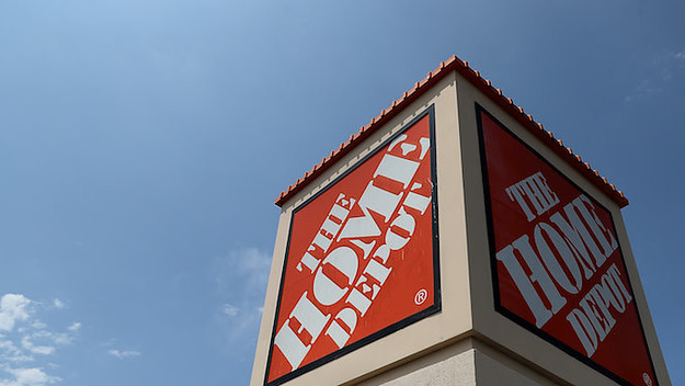 A sign is posted in front of a Home Depot store.