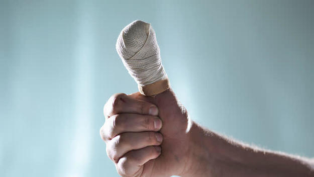 Stock photo of a bandaged thumb.