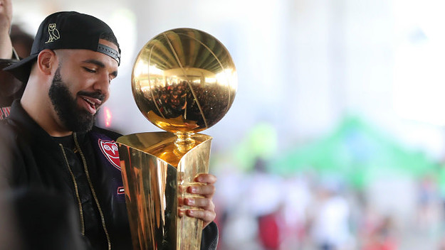 Drake holds the Larry O'Brien NBA Championship Trophy