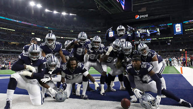 The Cowboys celebrate in the end zone after a score.