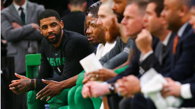 Kyrie Irving sits on the Celtics' bench