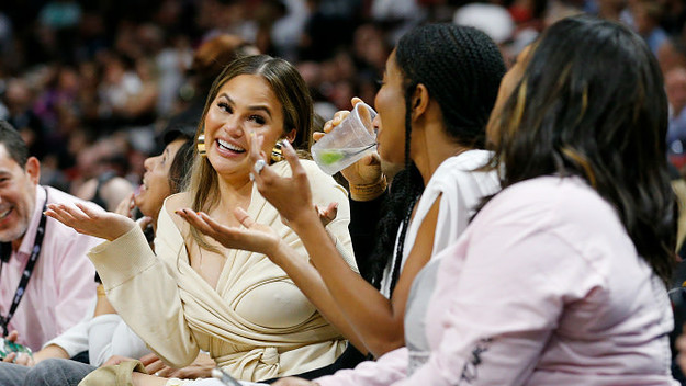 Chrissy Teigen reacts after Dwyane Wade crashed into her causing her