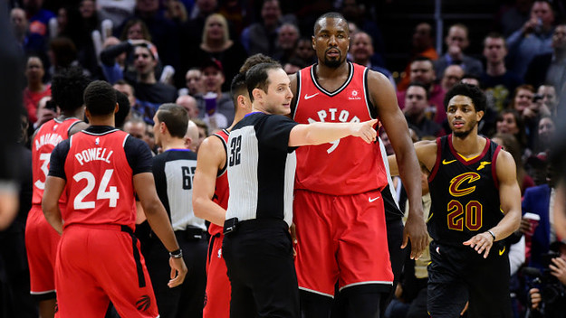 Referee Marat Kogut #32 directs Serge Ibaka #9 of the Toronto Raptors to the bench